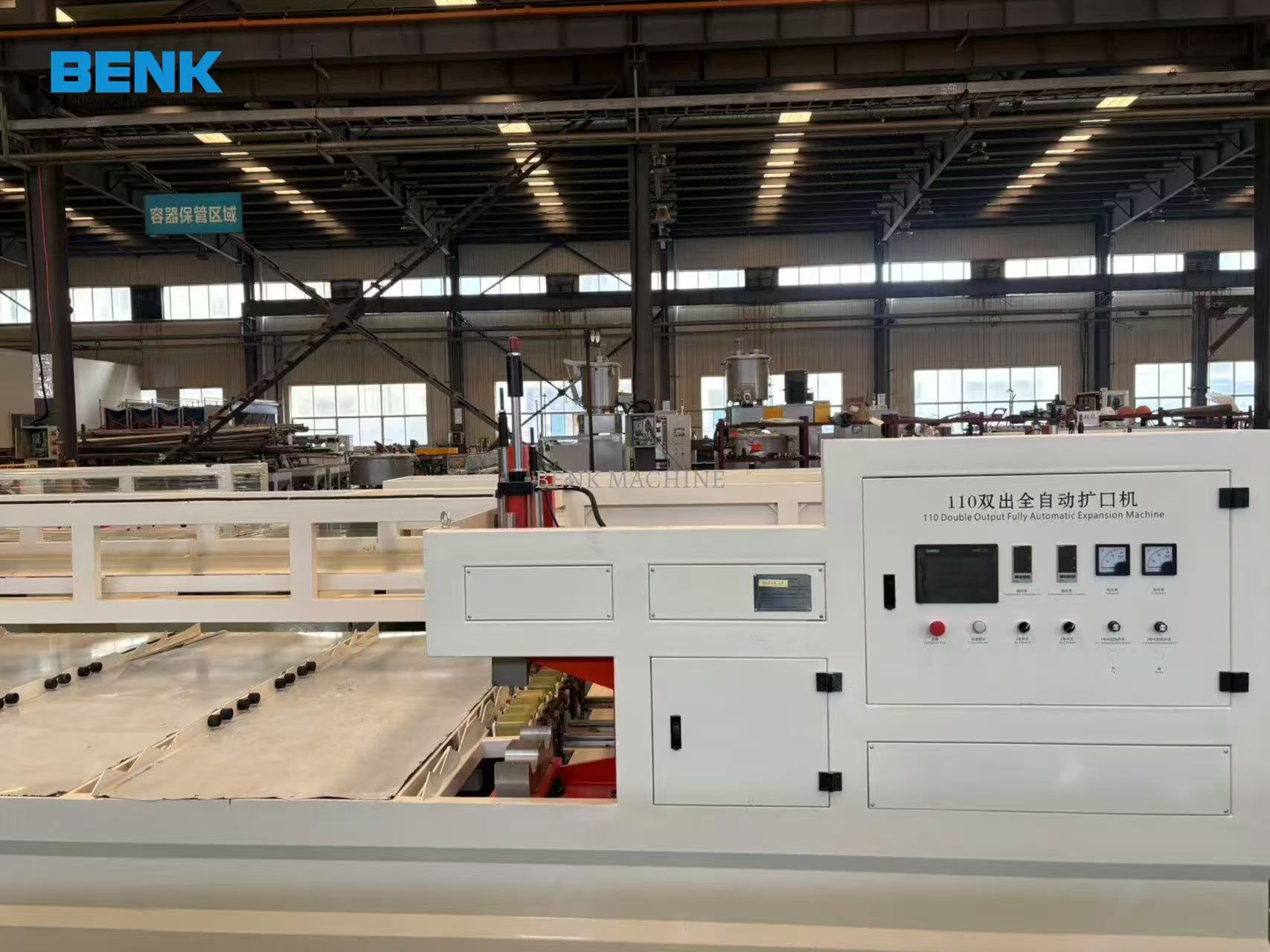 A PVC double-extrusion production line U-type expansion machine in a factory setting.